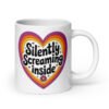 White ceramic coffee mug with a colorful graphic that says 'Silently screaming inside'. The graphics are printed on both sides of the mug.