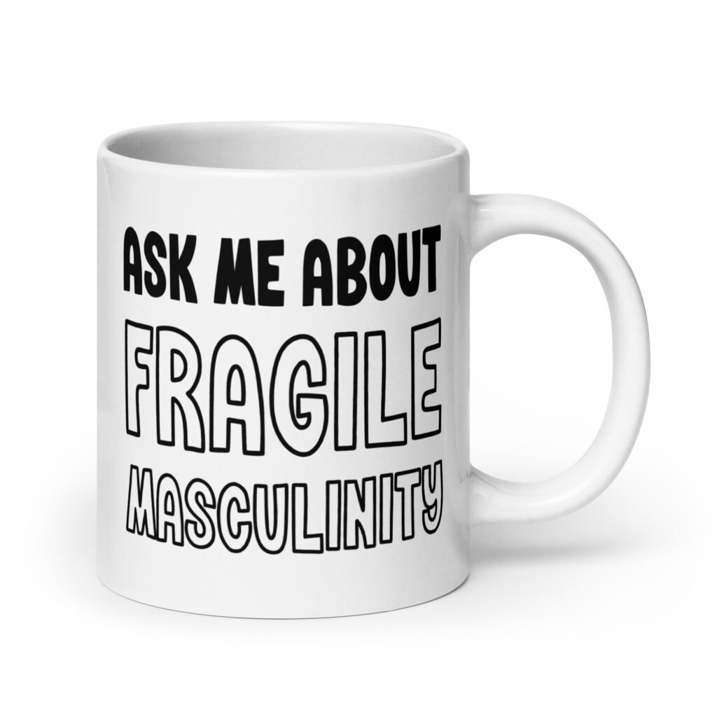 White ceramic coffee mug with the text 'Ask me about fragile masculinity' printed on both sides.