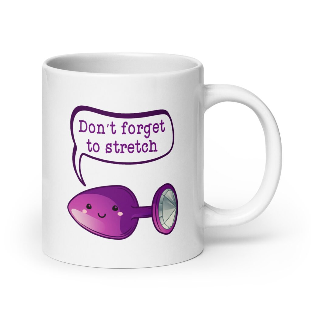 White ceramic coffee mug that has image of a purple anal plug with a smile face. There is a speech bubble above with the words 'Don't forget to stretch'. The graphics are printed on both sides of the mug.