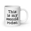 White ceramic mug with the text 'This is my second rodeo.' printed on both sides of the mug.