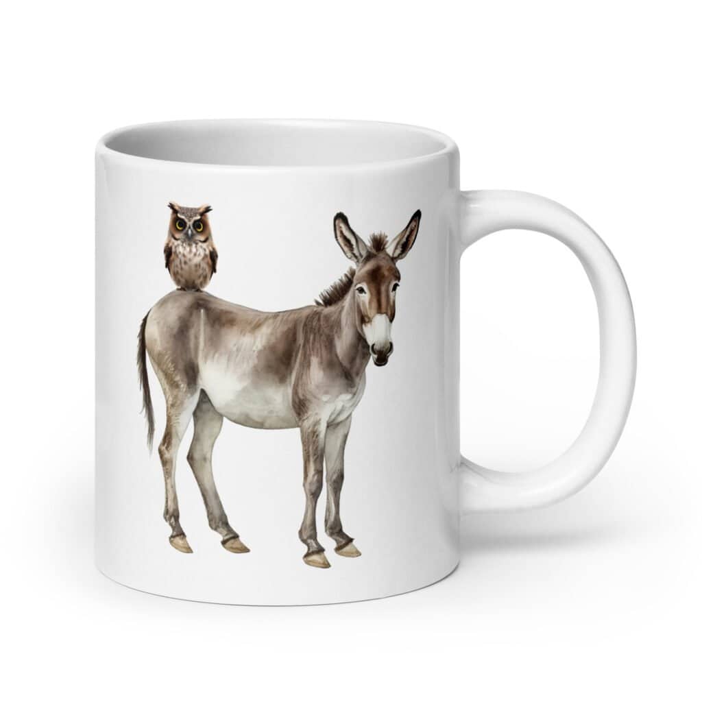 White ceramic coffee mug with an image of a donkey with wise owl sitting on it printed on both sides of the mug.