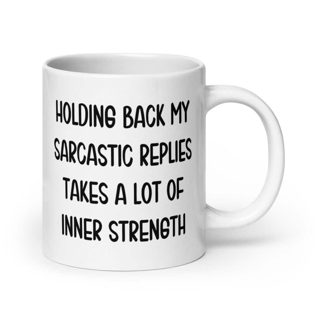 White ceramic mug with the phrase 'Holding back my sarcastic replies takes a lot of inner strength' printed on both sides of the mug.