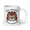White ceramic mug with image of 2 mermaids and the text 'Real mermaids smoke seaweed' printed on both sides.