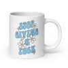 White ceramic coffee mug with a retro daisy and star design and the text 'Stop giving a fuck' printed on both sides.