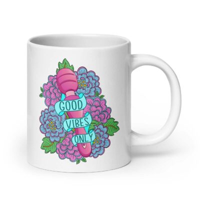White ceramic coffee mug with graphic design that has the words 'Good vibes only' layered over a pink wand vibrator with flowers around. The graphic design is printed on both sides of the mug.