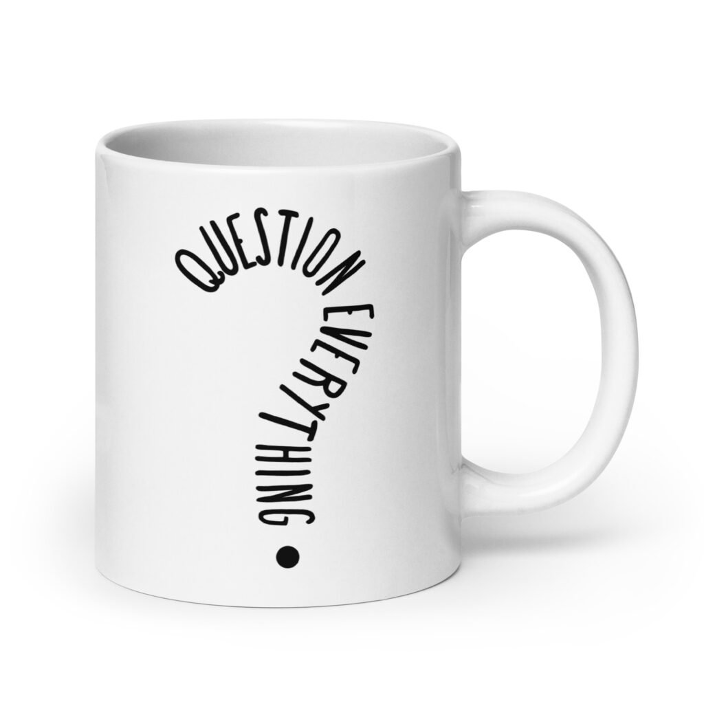 White ceramic coffee mug with the text 'Question everything' printed on both sides. The words are in the shape of a question mark.