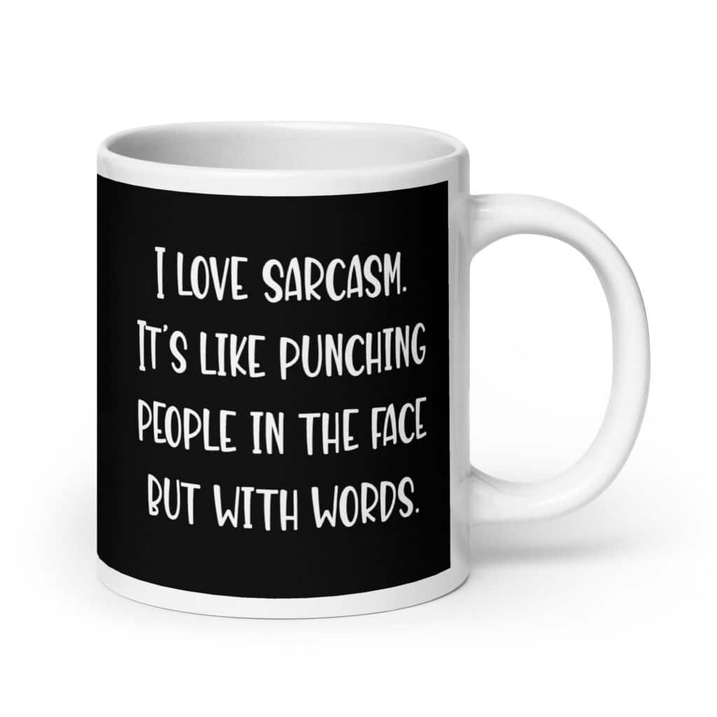 Black and white coffee mug with the text 'I love sarcasm. It's like punching people in the face but with words' printed on both sides.