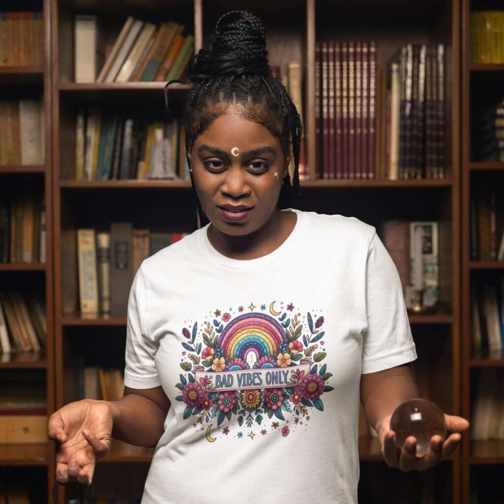 Woman wearing a white t-shirt with a colorful boho rainbow floral design and the text 'Bad Vibes Only' printed on the front.