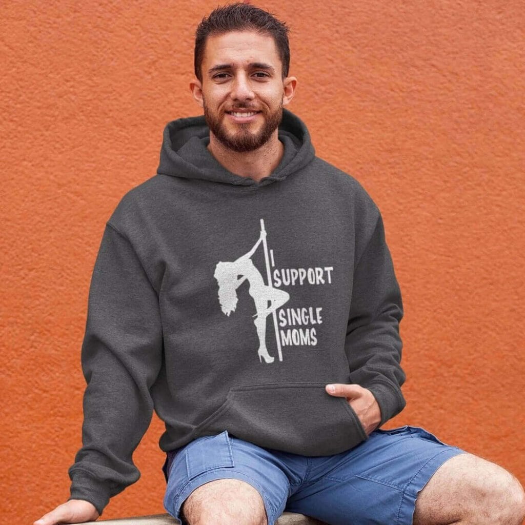 Man wearing a dark heather grey stripper humor hoodie sweatshirt with image of pole dancer and the text 'I support single moms' printed on the front.