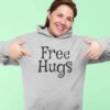 Woman wearing a light sport grey hoodie sweatshirt with the text 'Free Hugs' printed on the front.