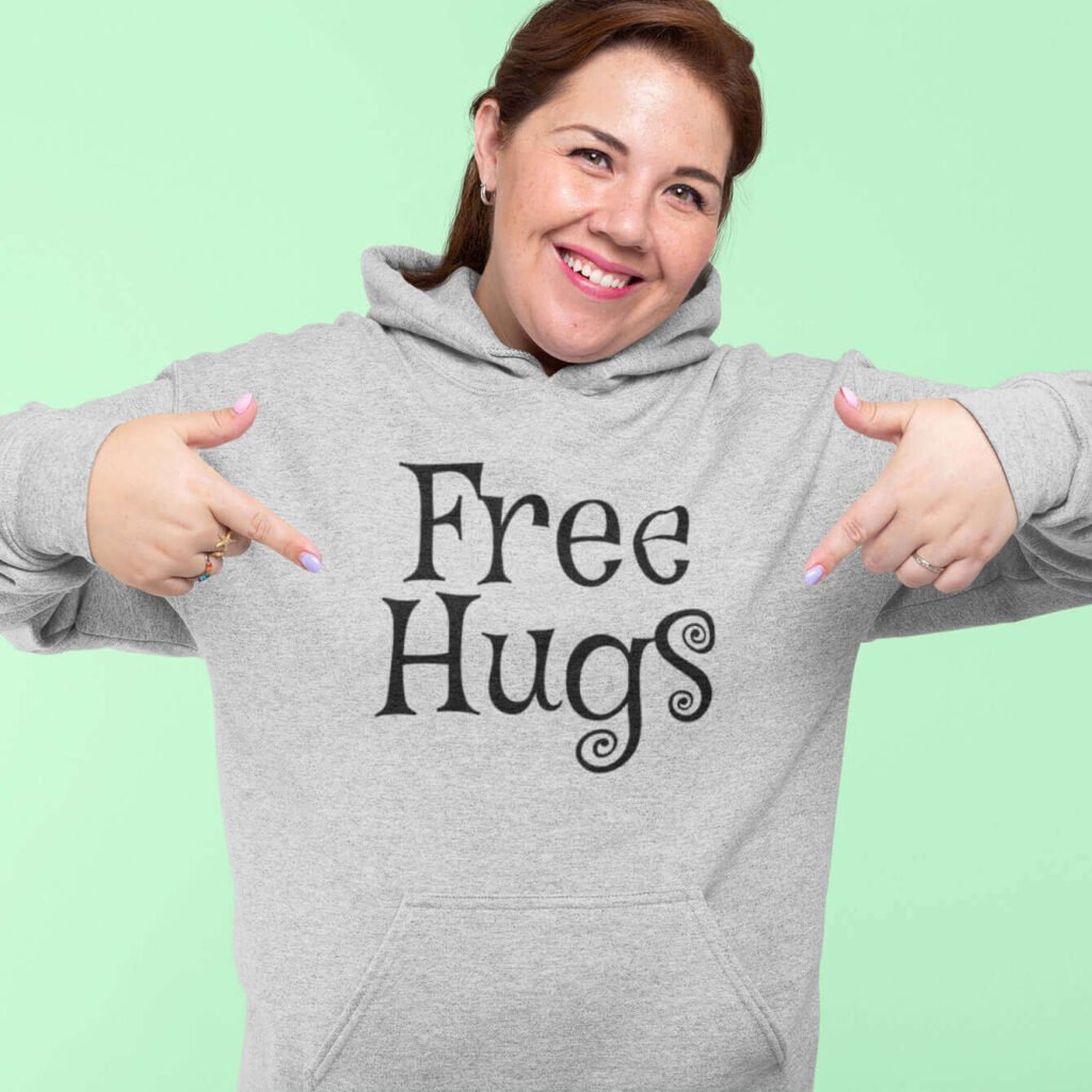 Woman wearing a light sport grey hoodie sweatshirt with the text 'Free Hugs' printed on the front.