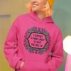Woman wearing a heliconia pink color hoodie sweatshirt with a colorful doodle graphic and the text 'I support a man's right to shut the hell up' printed on the front.