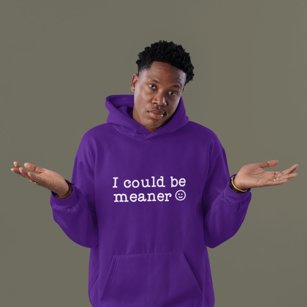Man wearing a purple hoodie sweatshirt with the text 'I could be meaner' printed on the front.