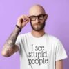 Man wearing a white t-shirt with the text 'I see stupid people' printed on the front.