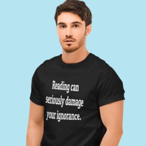 Man wearing a black t-shirt with the text 'Reading can seriously damage your ignorance.' printed on the front.