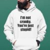 Man wearing a white with the text 'I'm not cranky. You're just stupid!' printed on the front.