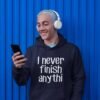 Man wearing a navy blue hoodie sweatshirt with the text 'I never finish anyth' printed on the front.