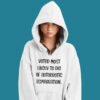 Woman wearing white hoodie sweatshirt with the hood up covering some of her face. The hoodie has the text 'Voted most likely to die of autoerotic asphyxiation.' printed on the front.