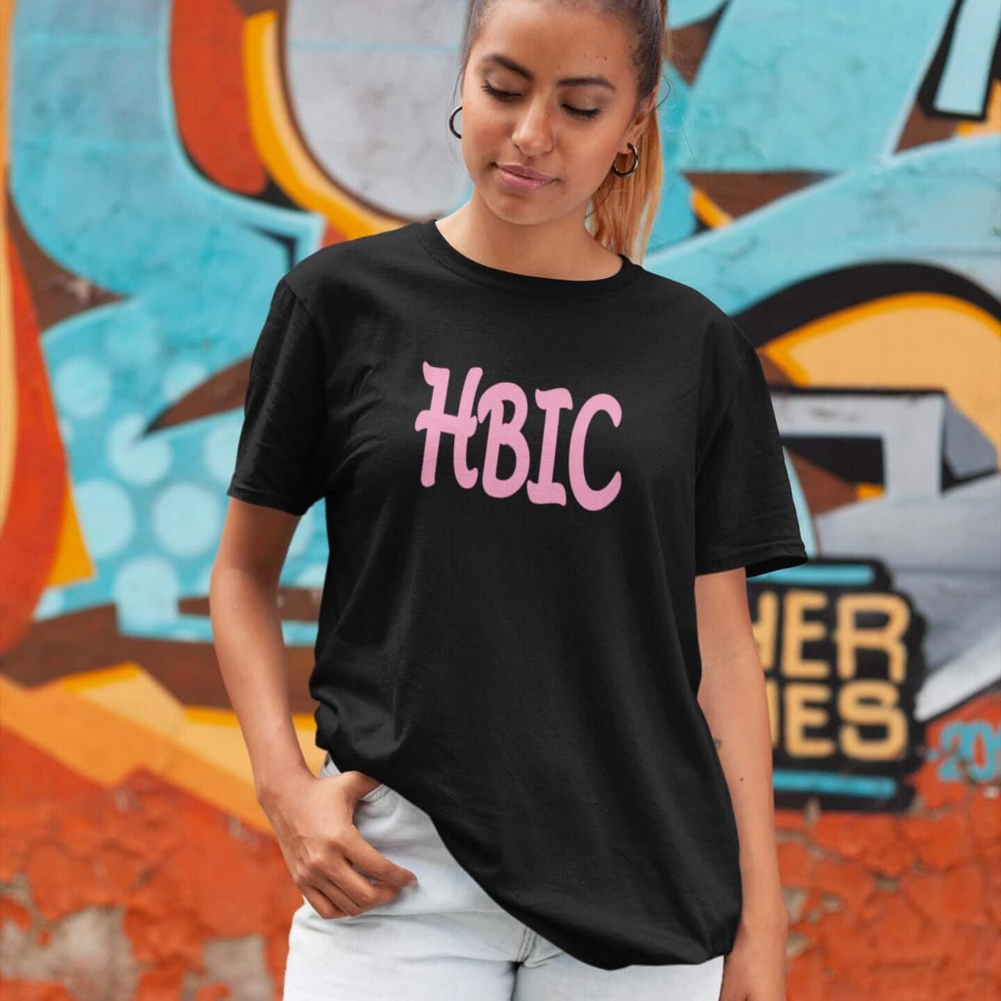 Woman wearing black t-shirt with the acronym HBIC printed on the front in pink text.