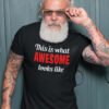 Handsome bearded man wearing a black t-shirt with the text 'This is what awesome looks like' printed on the front.