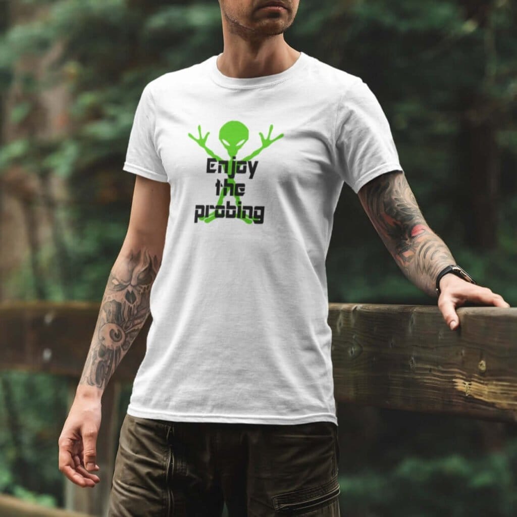 Man wearing a white t-shirt with an image of a green alien and the text 'Enjoy the probing' printed on the front.