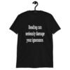 Black t-shirt with the text 'Reading can seriously damage your ignorance.' printed on the front.