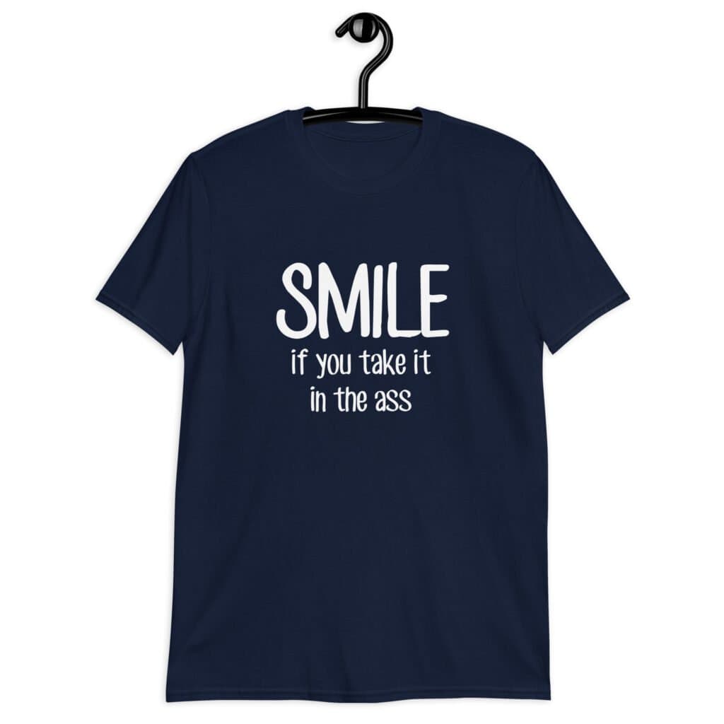 Navy blue t-shirt with the text 'Smile if you take it in the ass' printed on the front. The word 'smile' is large and the words 'take it in the ass' are much smaller.