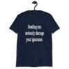 Navy blue t-shirt with the text 'Reading can seriously damage your ignorance.' printed on the front.