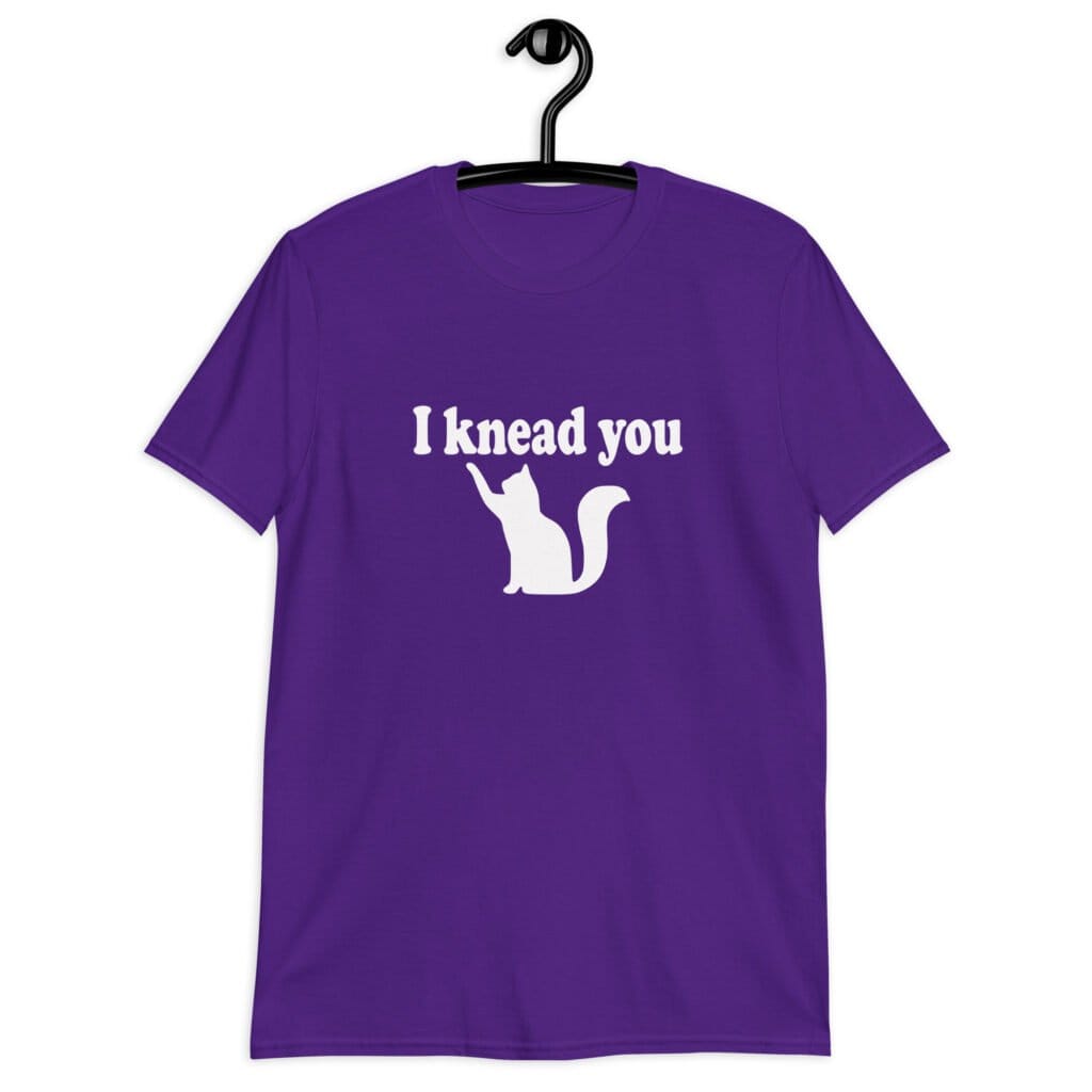 Purple t-shirt that has an image of a silhouette of a cat and the text 'I knead you' printed on the front.