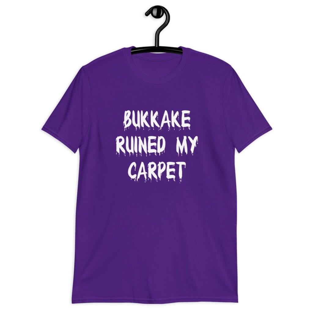 Purple t-shirt with the text 'Bukkake ruined my carpet' in drippy font printed on the front.