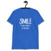 Royal blue t-shirt with the text 'Smile if you take it in the ass' printed on the front. The word 'smile' is large and the words 'take it in the ass' are much smaller.