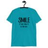 Tropical blue t-shirt with the text 'Smile if you take it in the ass' printed on the front. The word 'smile' is large and the words 'take it in the ass' are much smaller.