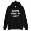 Black hoodie sweatshirt with the text 'Bukkake ruined my carpet' in drippy font printed on the front.
