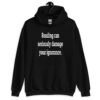 Black hoodie sweatshirt with the text 'Reading can seriously damage your ignorance.' printed on the front.