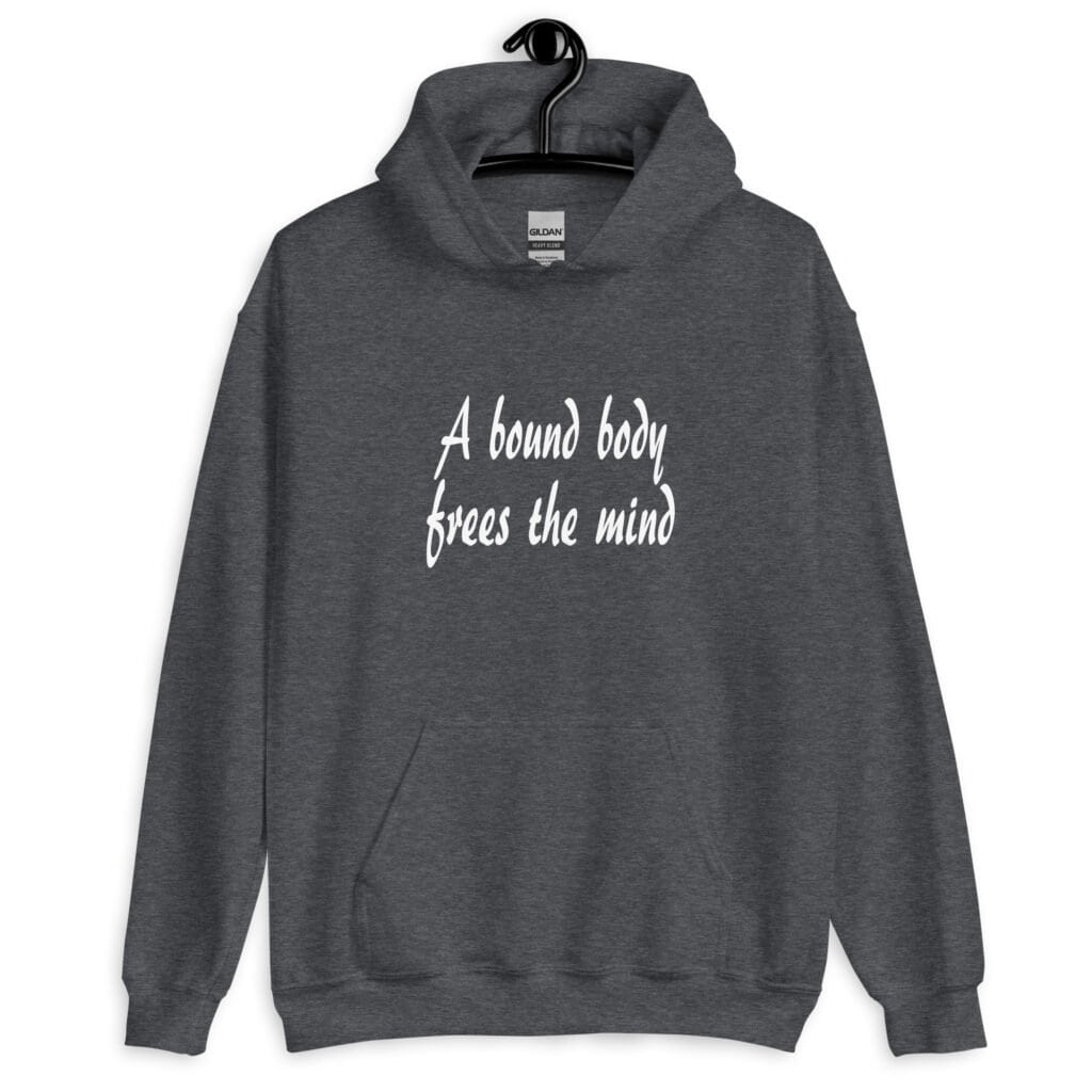 Dark heather grey hoodie sweatshirt with the text 'A bound body frees the mind' printed on the front.