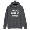 Dark heather grey hoodie sweatshirt with the text 'Bukkake ruined my carpet' in drippy font printed on the front.