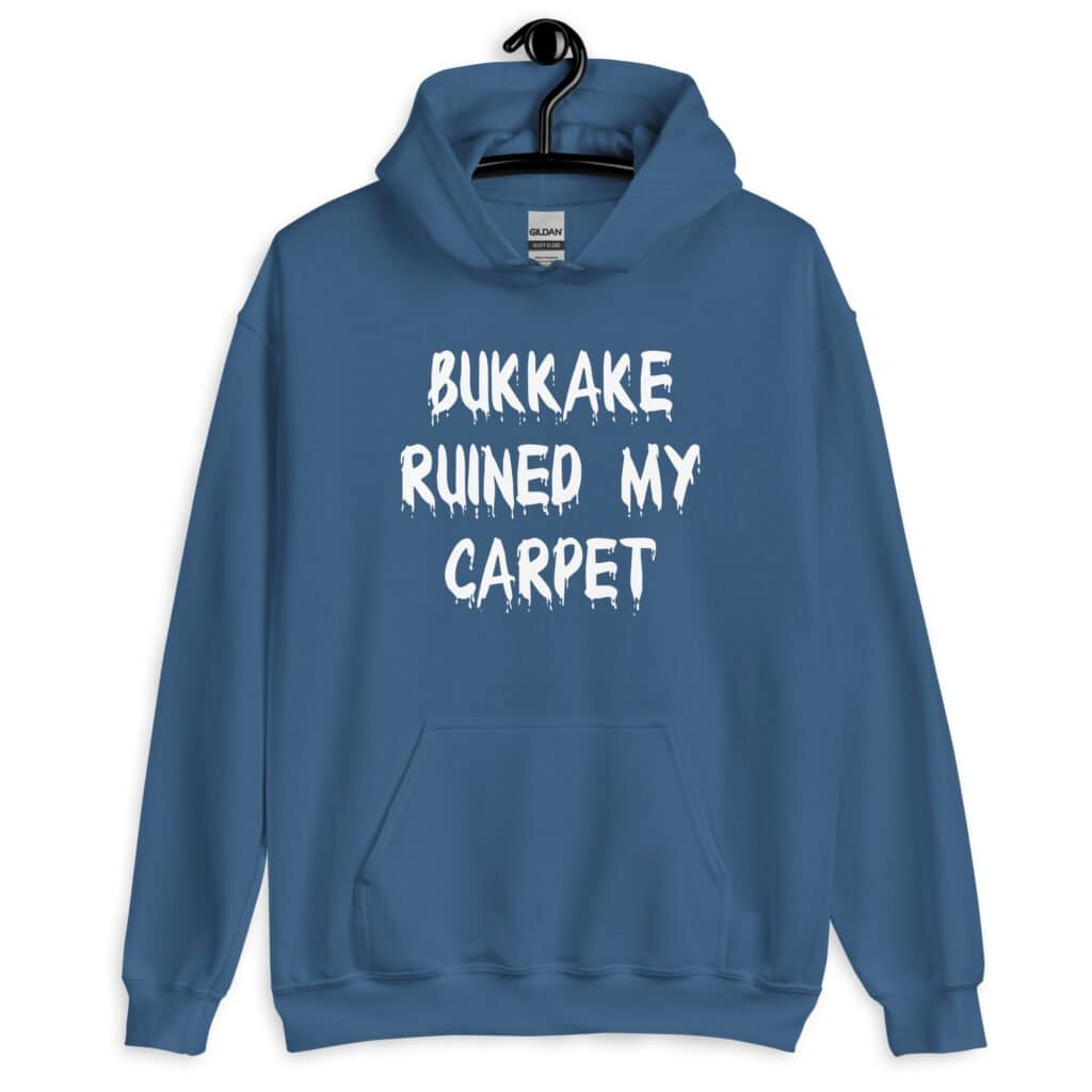 Indigo blue hoodie sweatshirt with the text 'Bukkake ruined my carpet' in drippy font printed on the front.