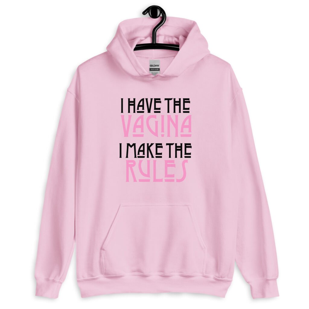 Light pink hoodie sweatshirt with the text 'I have the vagina. I make the rules' printed on the front.