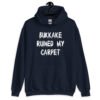 Navy blue hoodie sweatshirt with the text 'Bukkake ruined my carpet' in drippy font printed on the front.