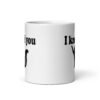 White ceramic coffee mug that has an image of a silhouette of a cat and the text 'I knead you' printed on both sides of the mug.