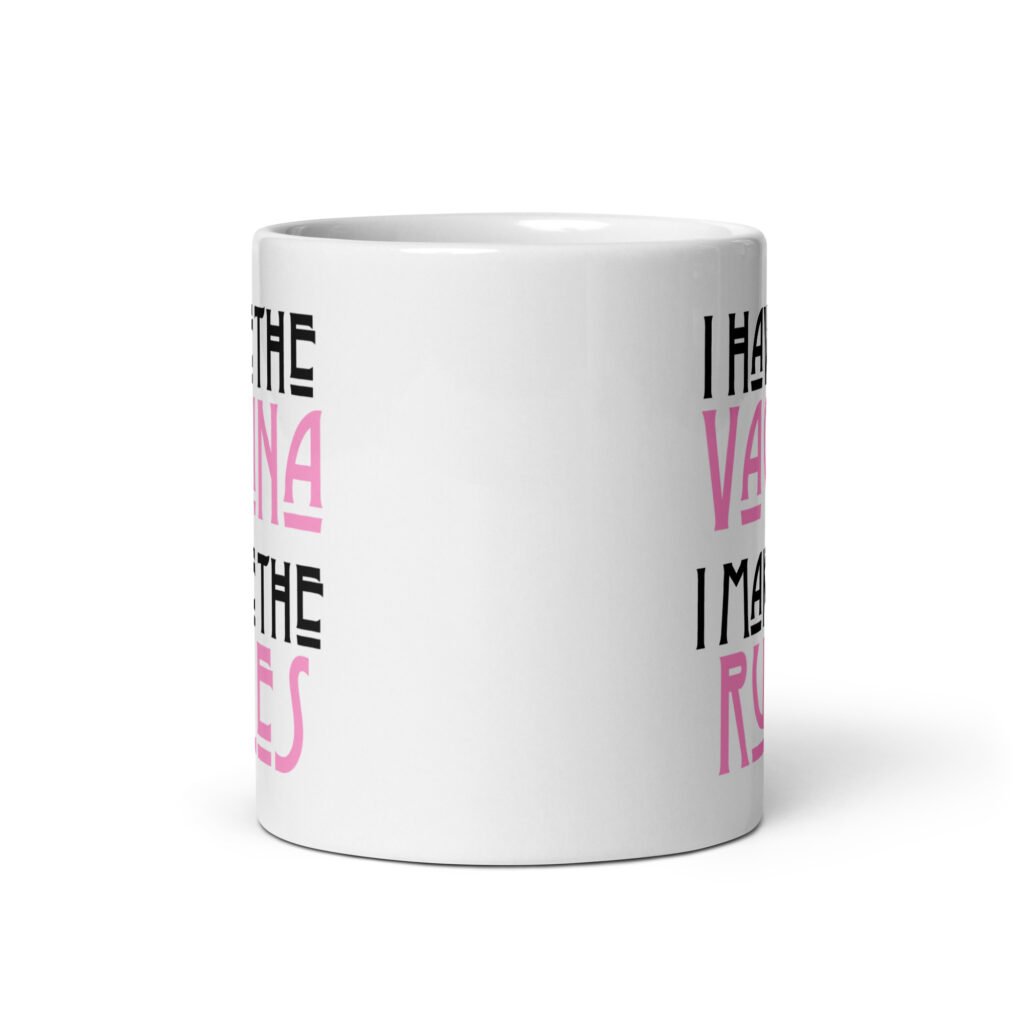 White ceramic coffee mug with the text 'I have the vagina. I make the rules' printed on both sides.
