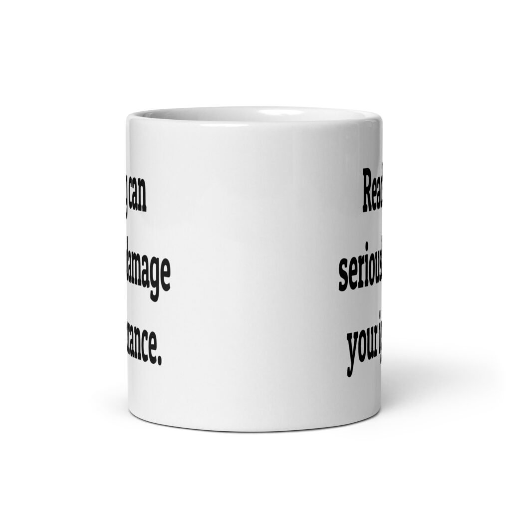 White ceramic coffee mug with the text 'Reading can seriously damage your ignorance.' printed on both sides.