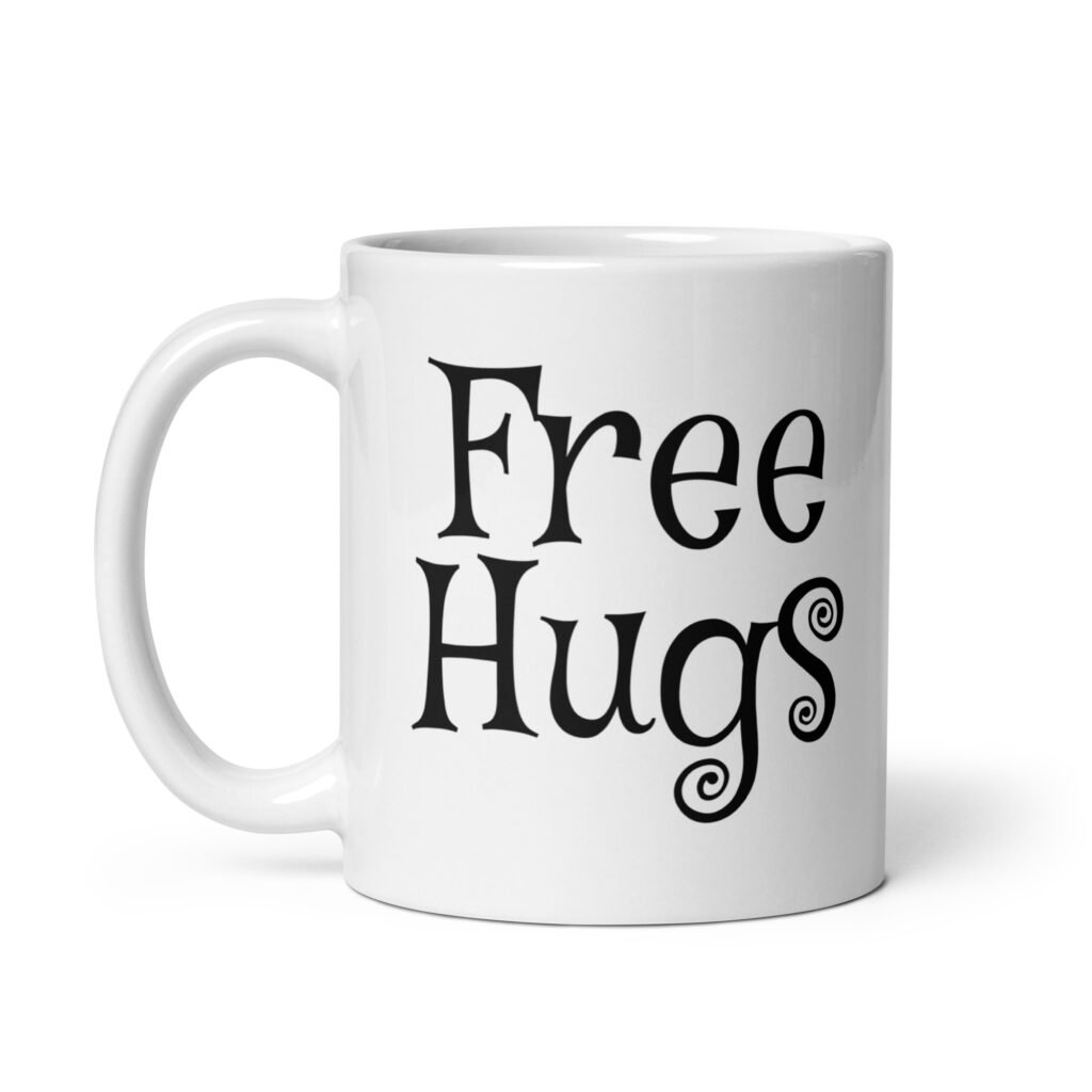 White ceramic coffee mug with the text 'Free Hugs' printed on both sides.