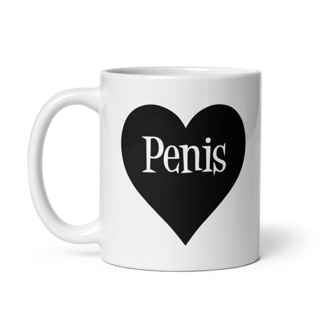 White ceramic coffee mug with a heart image printed on both sides. The word 'Penis' is inside the heart.
