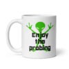 White ceramic coffee mug with an image of a green alien and the text 'Enjoy the probing' printed on both sides of the mug.