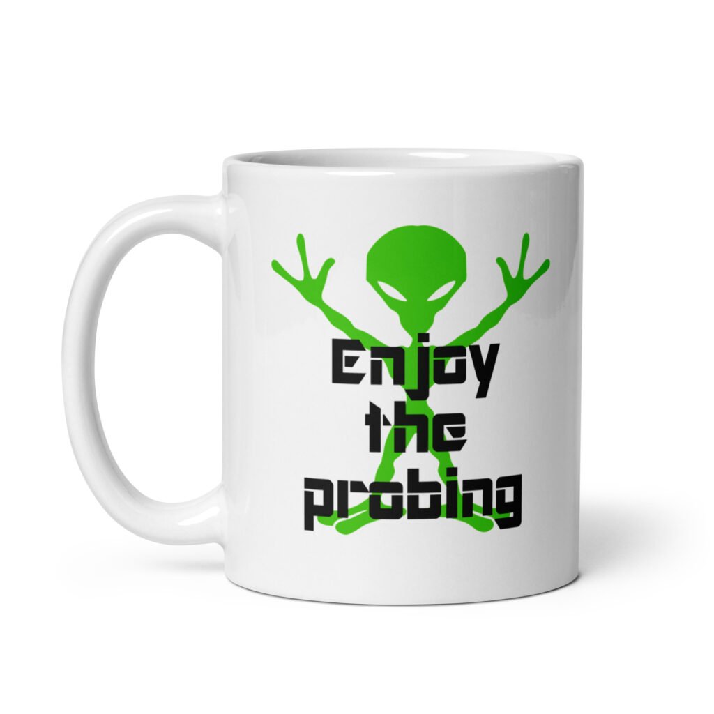 White ceramic coffee mug with an image of a green alien and the text 'Enjoy the probing' printed on both sides of the mug.
