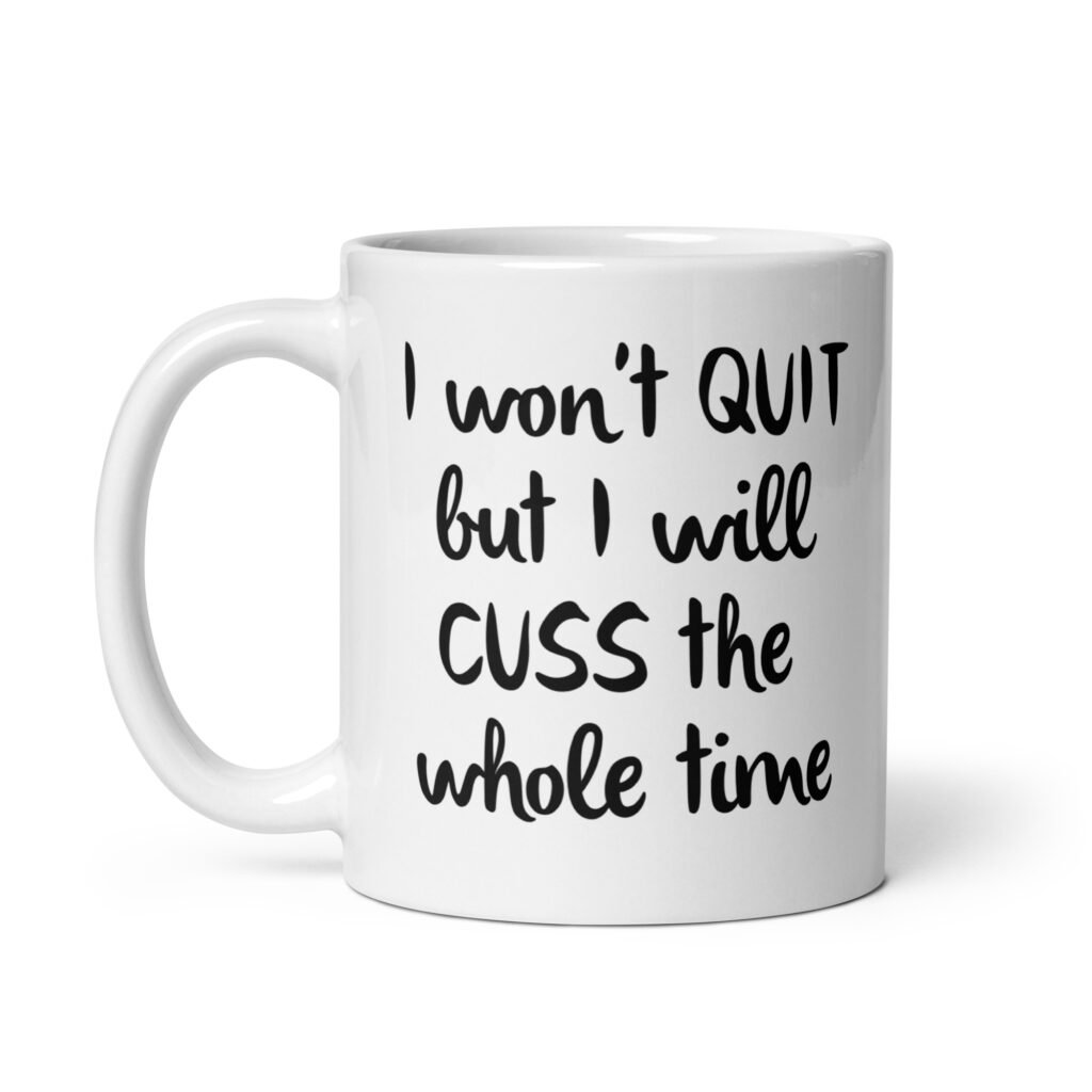 White ceramic coffee mug with the text 'I won't QUIT but I will CUSS the whole time' printed on both sides.