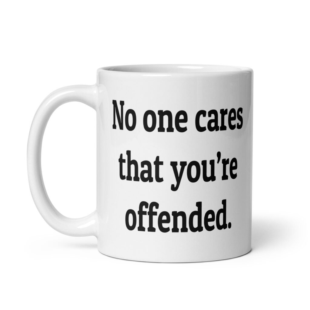 White ceramic coffee mug with the text "No one cares that you're offended.' printed on both sides.