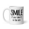 White ceramic mug with the text 'Smile if you take it in the ass' printed on both sides. The word 'smile' is large and the words 'take it in the ass' are much smaller.