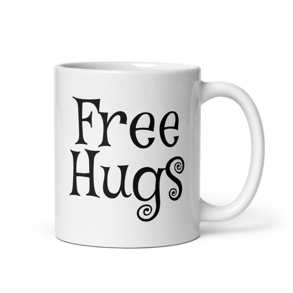 White ceramic coffee mug with the text 'Free Hugs' printed on both sides.